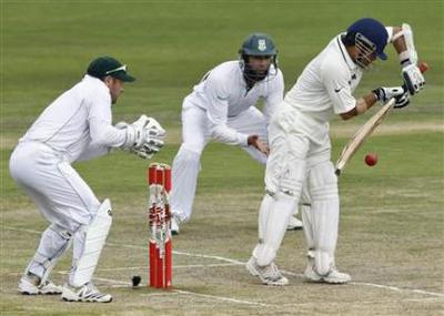 India's Tendulkar plays a shot as South Africa's Boucher and Amla watch during the fourth day of their first test cricket match in Pretoria